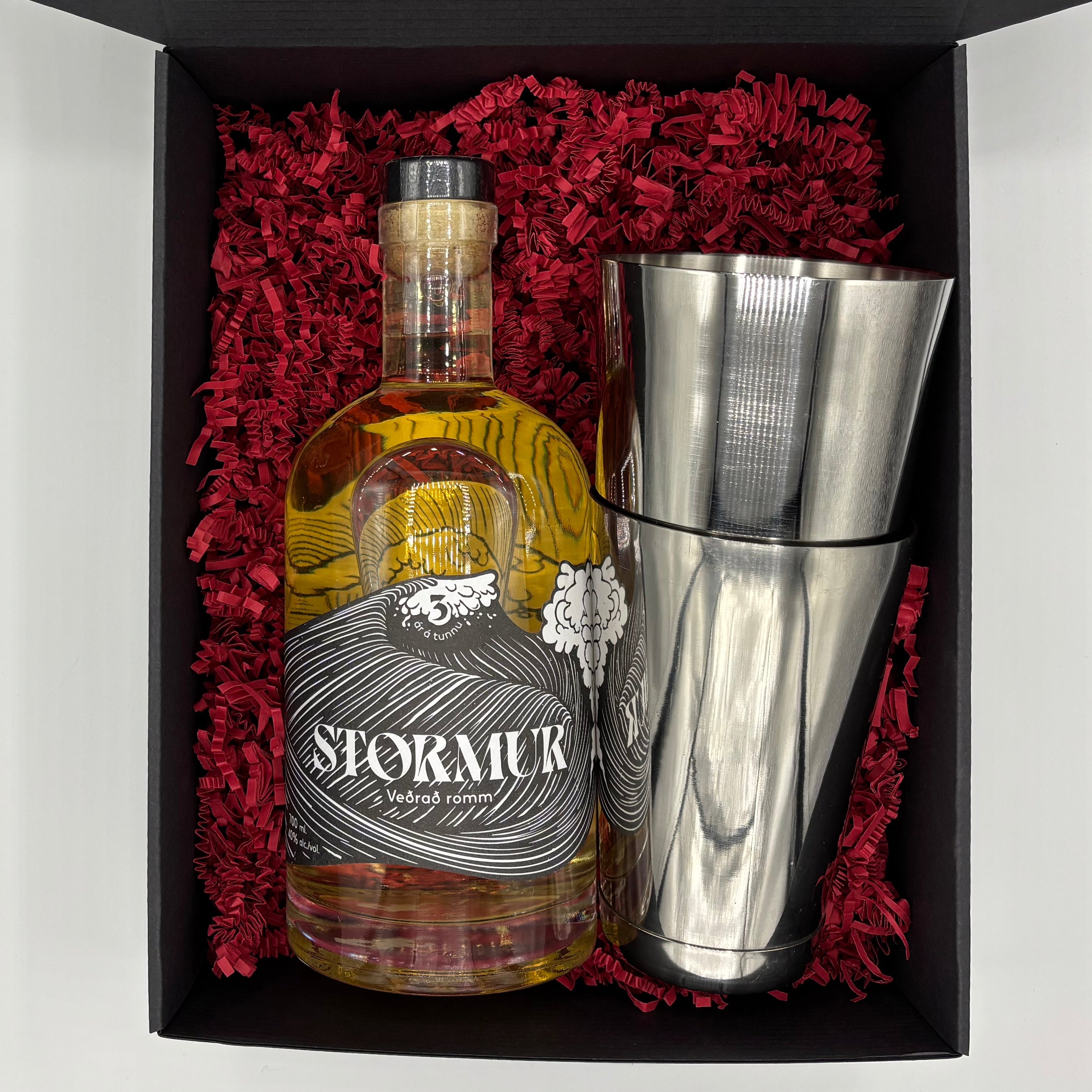Bottle of Stomur rum with a cocktail shaker in a decorative box.